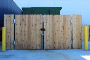 A commercial wooden privacy fence and gate for a dumpster enclosure installed by Fence Company Chicago in Chicago, IL