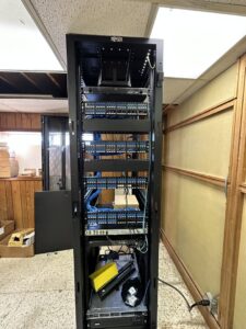 A communication server rack with neatly organized network cabling and equipment installed by Babcock Electric & Communications in Lake Charles, LA.