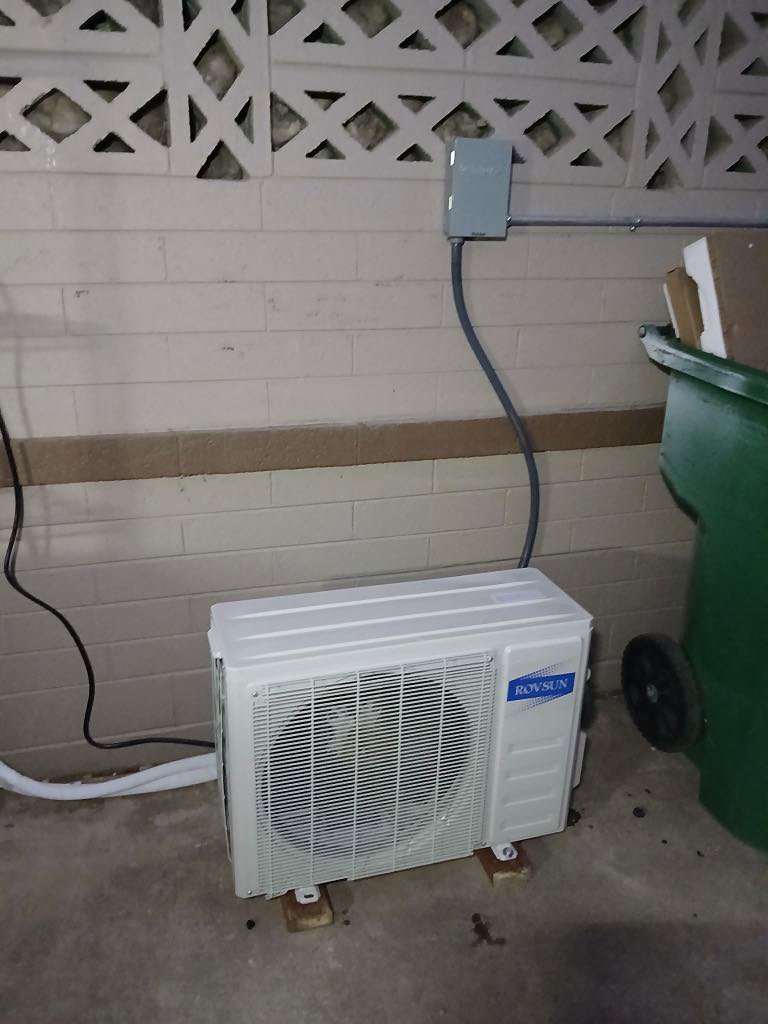 A compact outdoor mini-split condenser unit installed by BH cooling & Heating in Glendale, AZ.