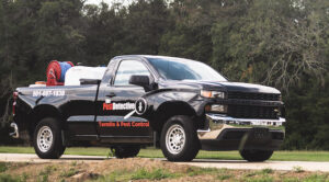 A black company pickup truck with 'The Pest Detective' branding, used for services in Cleveland, OH.
