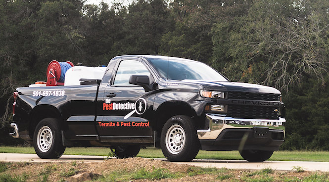 A black company pickup truck with 'The Pest Detective' branding, used for services in Cleveland, OH.