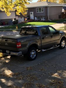 An Omaha Pest Control, Inc. company truck parked at a residence for pest control service in Omaha, NE.