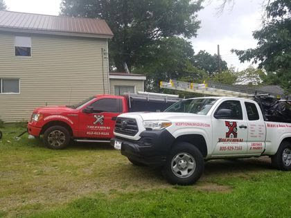 Xceptional Wildlife Removal Jacksonville, FL, company trucks parked at a residential property, ready for service.