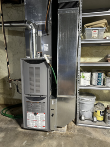 A complete indoor furnace and air handler system with ductwork, appearing well-maintained, by Friess Heating & Air Conditioning in Topeka, KS