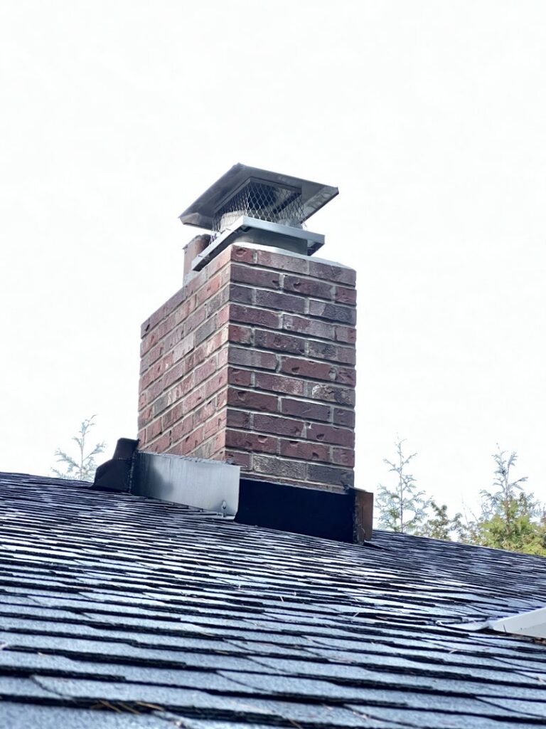 A completed brick chimney repair with a new cap, showcasing professional work by Five Star Chimney Repair in Hillsboro, OR.