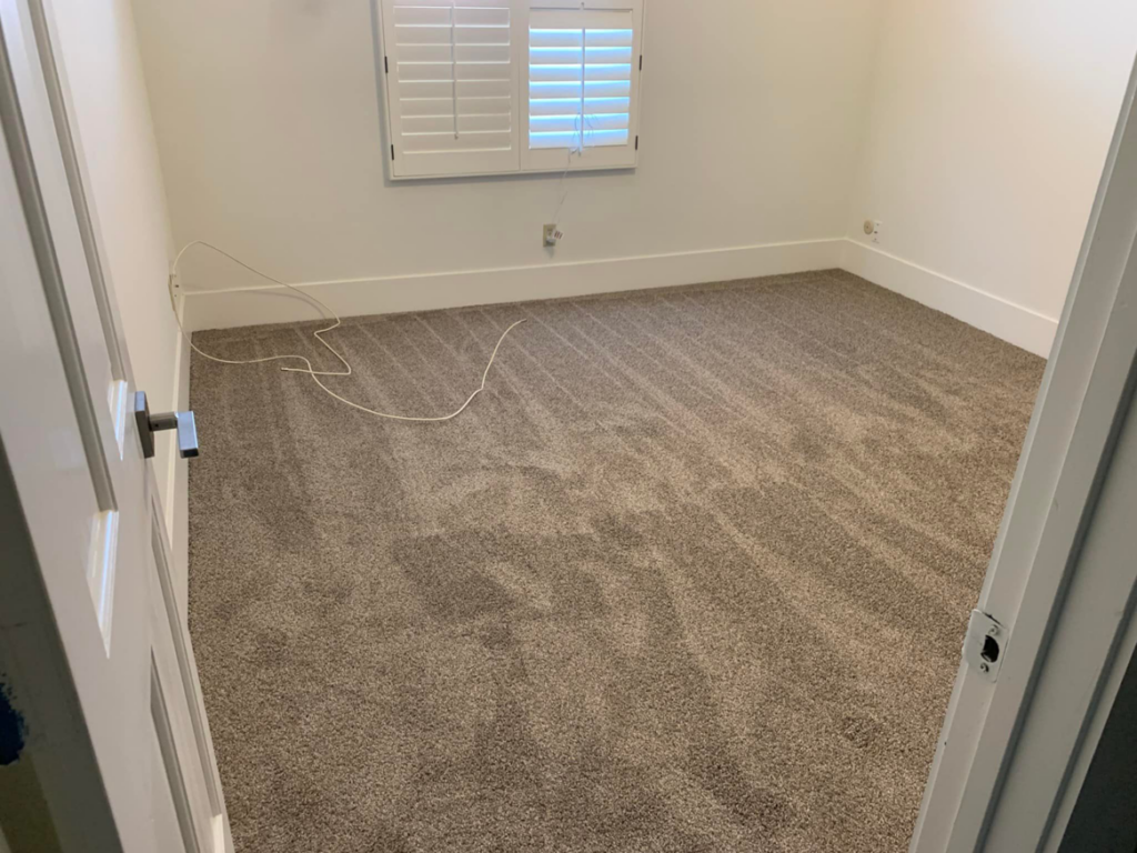 A completed brown carpet installation in a room, highlighting the professional service of Canyon State Flooring in Queen Creek, AZ.