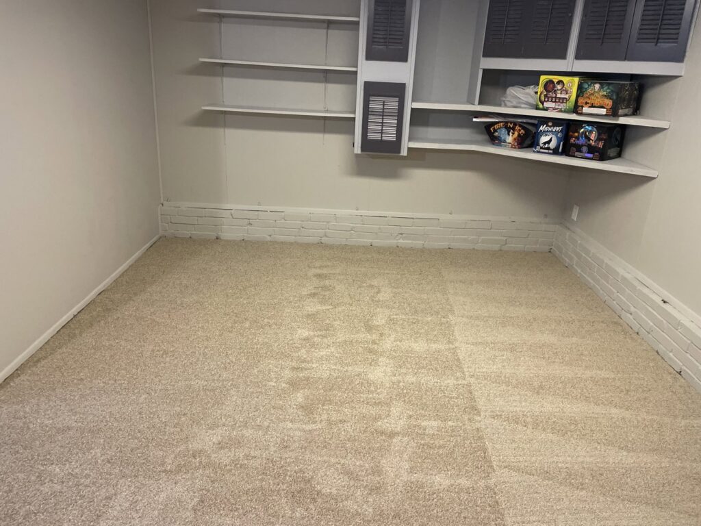 A completed carpet installation project in a room with built-in shelves by JJS Flooring & Decorating Co Inc in Saint Louis, MO.