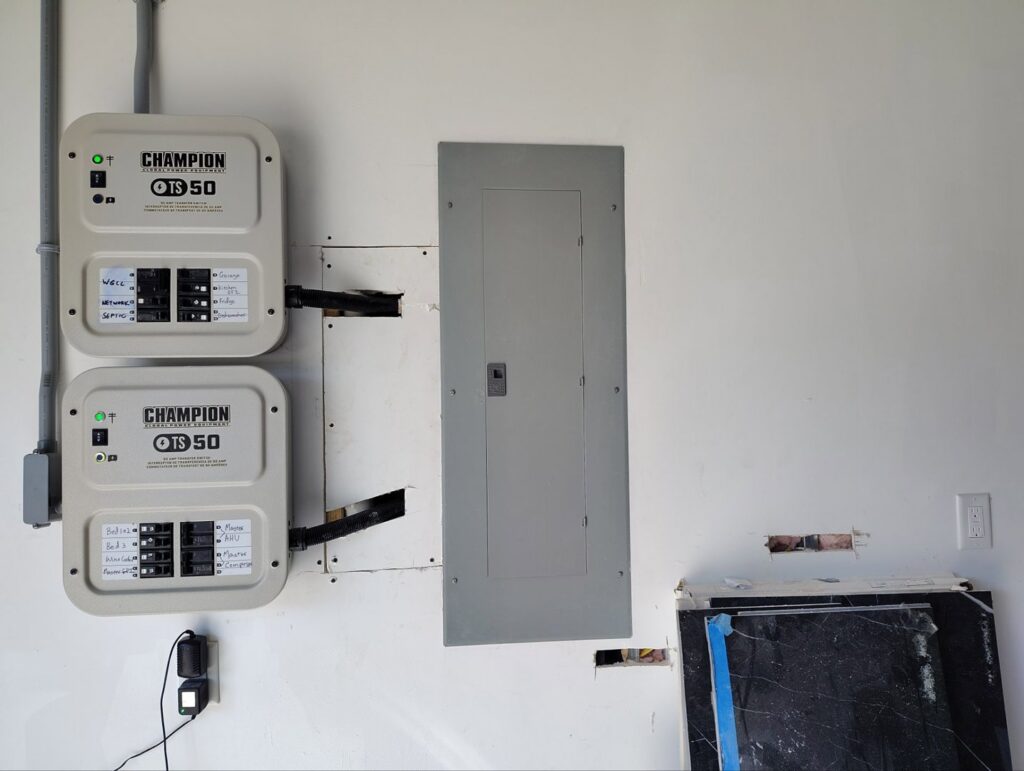 Completed installation of electrical panels and Champion transfer switches on a wall, showcasing professional electrical services by Envision Electrical Solutions in Fort Lauderdale, FL.