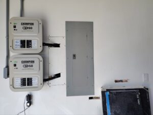 Completed installation of electrical panels and Champion transfer switches on a wall, showcasing professional electrical services by Envision Electrical Solutions in Fort Lauderdale, FL.