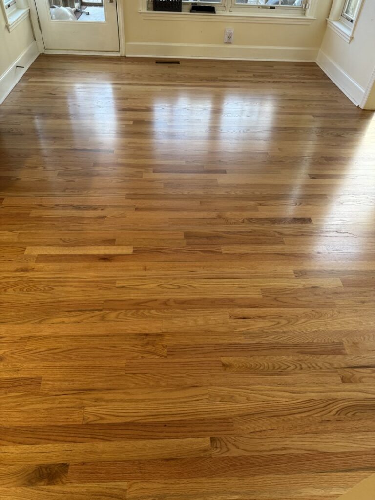 A completed hardwood floor installation project in a spacious room by Augusta Carpet Mart in Augusta, GA.