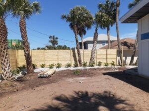 A newly completed horizontal wood privacy fence in a residential backyard by Julien Affordable Fencing LLC in Jacksonville, FL