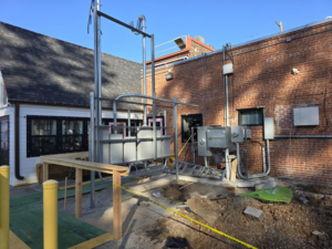 A wide view of a completed outdoor electrical service installation by Hummingbird Electric Inc. on a brick building in Tulsa, OK.