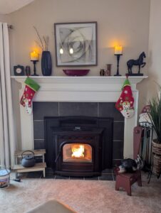 A cozy, completed pellet stove installation by Greer Enterprises, providing heating in Raymond, NH.