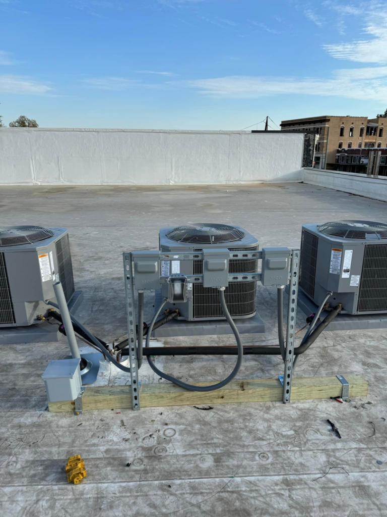 A completed rooftop HVAC electrical installation with multiple units and conduit by Redmond Electric LLC in Horn Lake, MS.