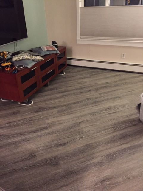 Completed vinyl plank flooring installation in a living room by Alaska Flor-Wall, Inc. in Anchorage, AK.