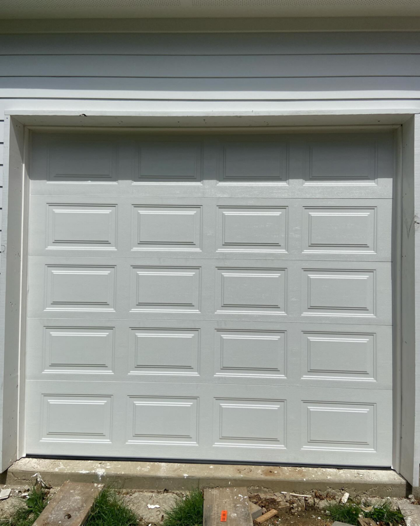 A completed installation of a white sectional garage door by J&C Bravo LLC, serving clients in Cordova, TN.