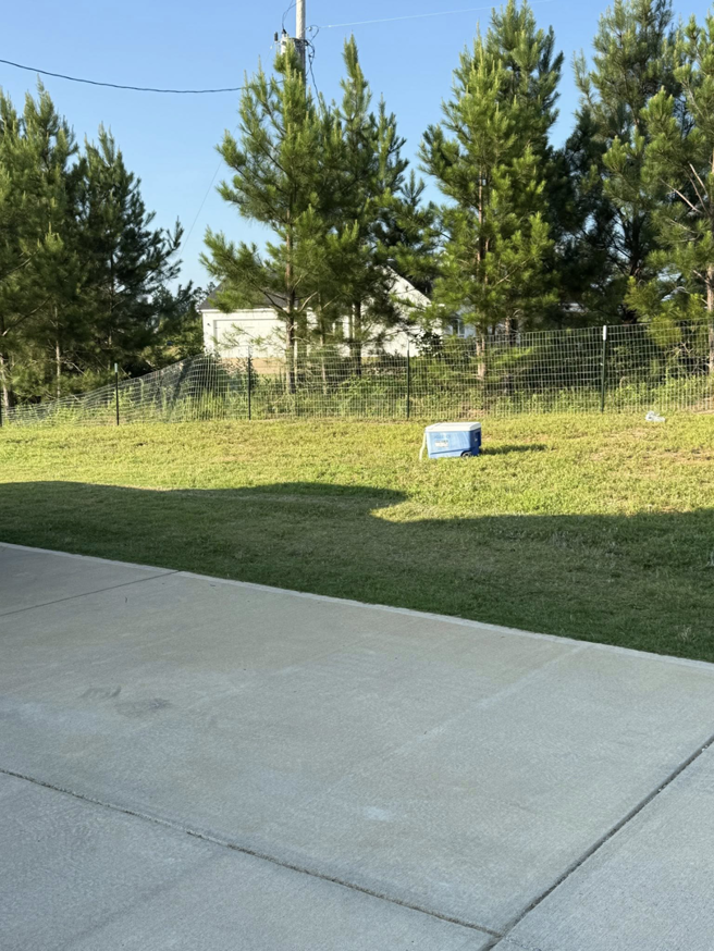 A newly installed wire fence enclosing a backyard, showcasing work by G2 Home Solutions in Phenix City, AL.