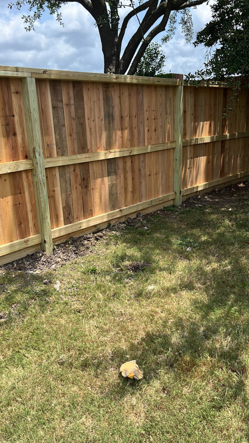 A section of a newly completed wooden fence in a backyard by Alexi's Handyman Services in Indianapolis, IN.
