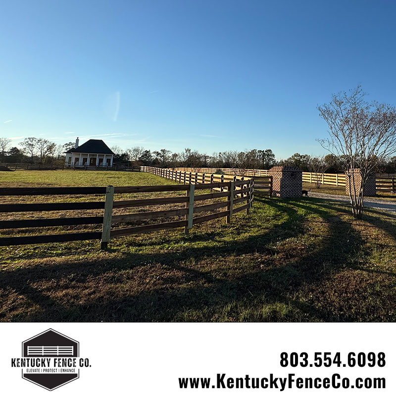 A completed wooden fence with a gate entrance and brick pillars installed by Kentucky Fence Co in McConnells, SC.