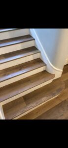 Newly installed wood flooring on a staircase, showcasing a completed project by Anaheim Carpet and Flooring in Anaheim, CA.