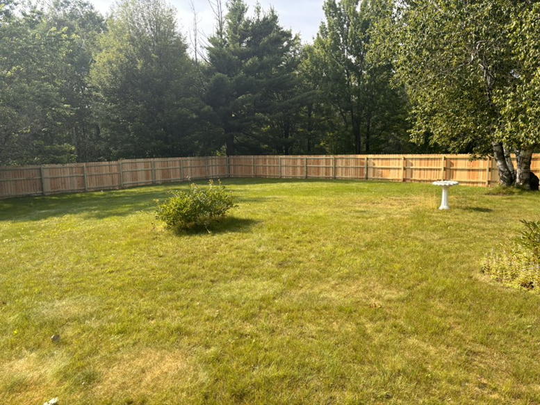 A large backyard with a newly completed wood privacy fence by 218 Fencing in Duluth, MN.