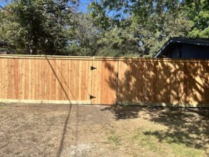 A completed wood privacy fence with a gate, showcasing quality work by GOAT Fence Company in Houston, TX.