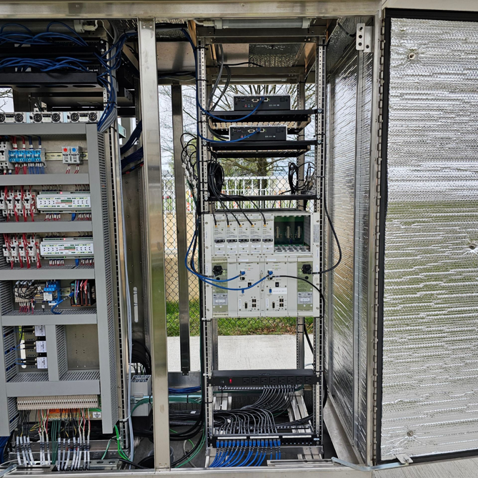 Intricate wiring and components inside a complex electrical and data cabinet, installed by ELEC LLC in Winston-Salem, NC.