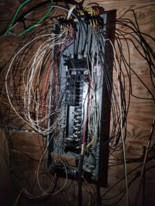A complex electrical panel with numerous wires, showing work by FOXX & Hounds Electric in Sioux City, IA.