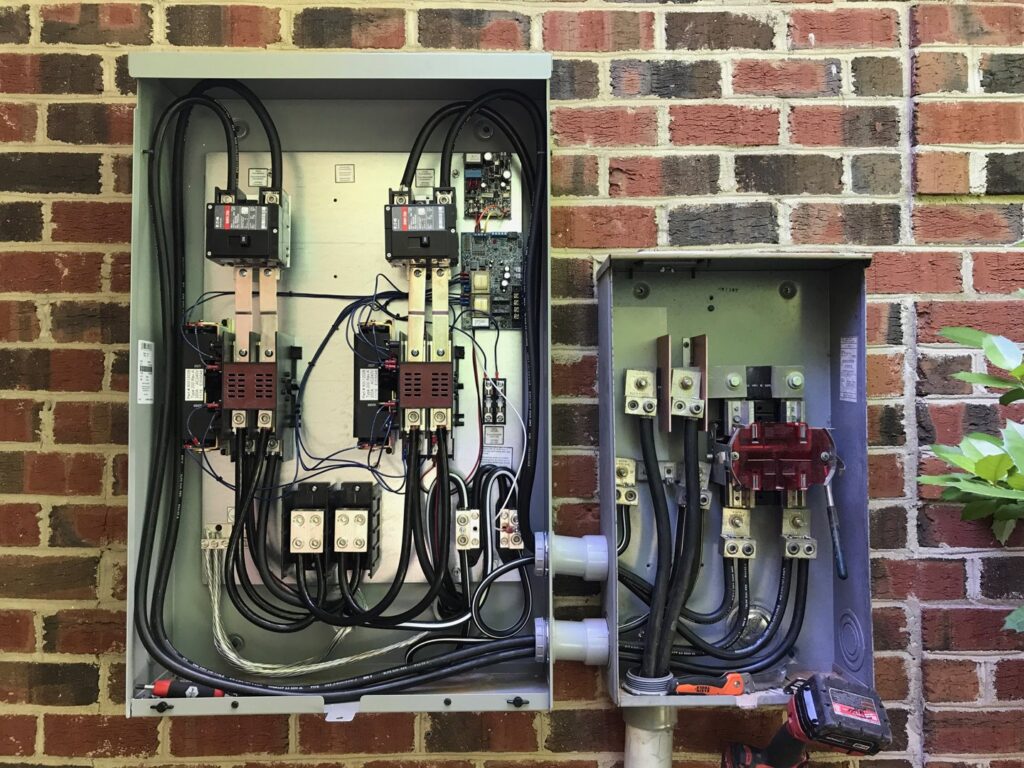 Complex exterior electrical panels with intricate wiring and components installed by Volt Doctors in Durham, NC