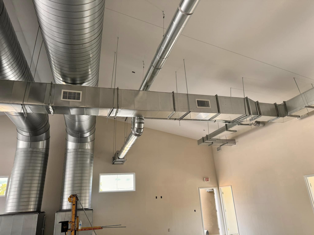 Complex HVAC duct system installation with various duct types by Buck'n Bull HVAC Solutions in Wilmington, NC