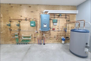 A large, complex hydronic heating system with a boiler, manifold, and hot water tank installed by Allied Heating and Air Conditioning in Port Richey, FL.