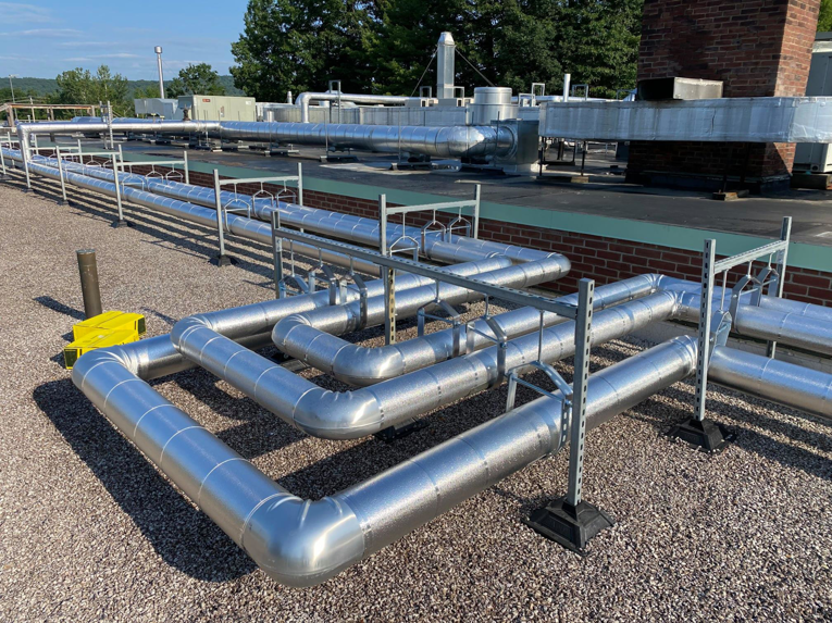 Complex network of insulated HVAC piping on a rooftop, installed by North Country Mechanical Insulators in South Burlington, VT.