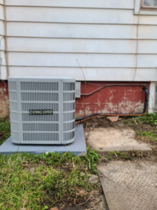 A newly installed Concord outdoor air conditioning unit next to a residential building by Guzman Heating & Cooling in Milwaukee, WI.
