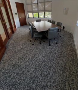 A modern conference room featuring newly installed grey speckled carpet by Rugs R Us Corporation in Fort Lauderdale, FL.