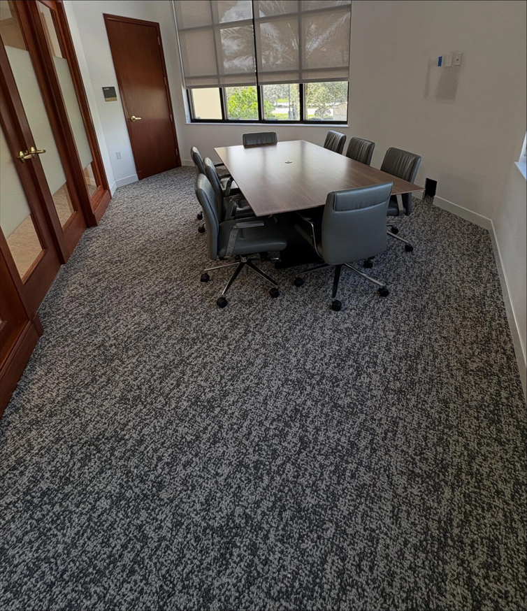 A modern conference room featuring newly installed grey speckled carpet by Rugs R Us Corporation in Fort Lauderdale, FL.
