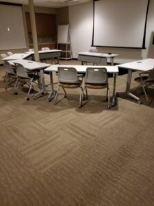 A conference room with newly installed patterned carpet tiles by Heather Mountain Flooring in Layton, UT.