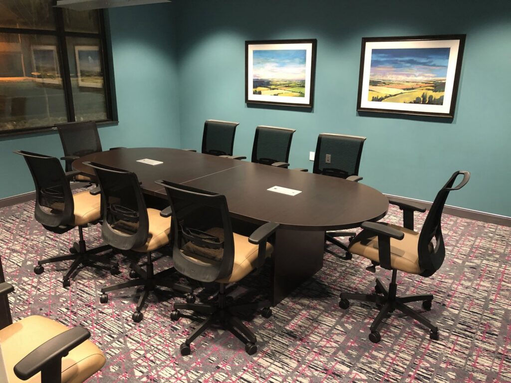 A modern conference room with stylish patterned carpet installed by Aaron's Facility Services, a carpet contractor in Detroit, MI.