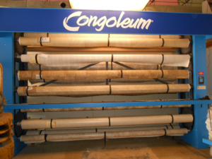 A display rack filled with rolls of Congoleum vinyl flooring at Frosty's Carpet Center, Inc. in Grand Forks, ND.