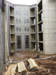 Piles of wood and construction debris in a building courtyard, ready for general junk removal by Stellar HVAC in Lawrenceville, GA.