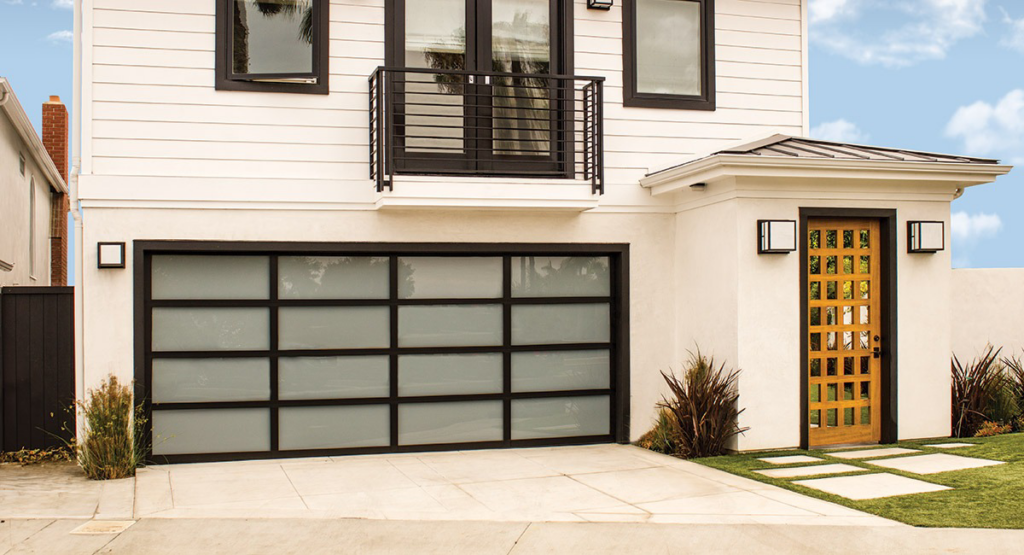 A contemporary black-framed garage door with frosted glass panels on a modern house, installed by Overhead Door of New Orleans in New Orleans, LA.
