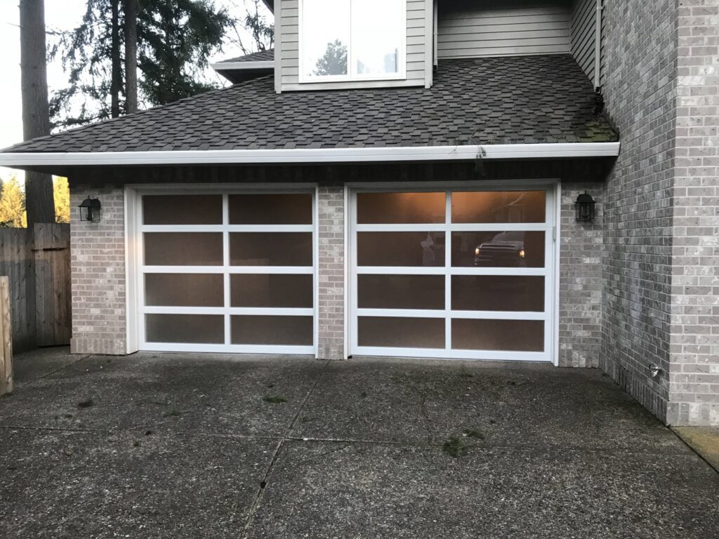 Two contemporary garage doors with frosted glass panels installed by Discount Garage Door Company in Spokane, WA.