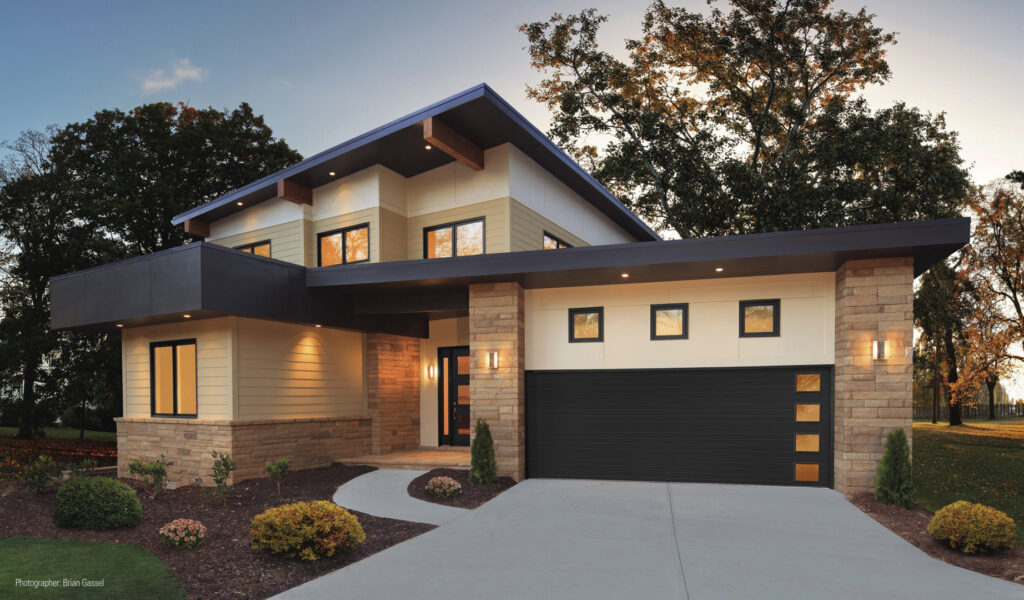 A contemporary home featuring a black garage door with horizontal windows, installed by Babcock Garage Doors in Vancouver, WA