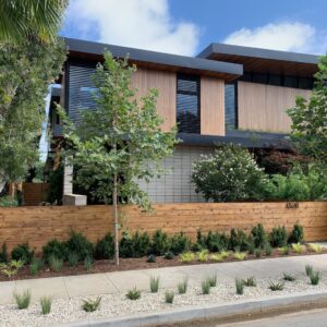 A contemporary house with a stylish wood fence installed in the front yard by Los Angeles Fence Builders in Los Angeles, CA.