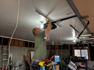 A contractor installing a garage door opener for Southern Colorado Garage Door in Pueblo, CO.