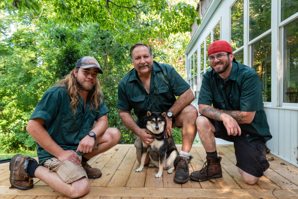 A garage door contractor installing the top trim or weather stripping on a new garage door for Annapolis Garage Doors Inc. in Annapolis, MD.
