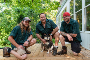 A garage door contractor installing the top trim or weather stripping on a new garage door for Annapolis Garage Doors Inc. in Annapolis, MD.