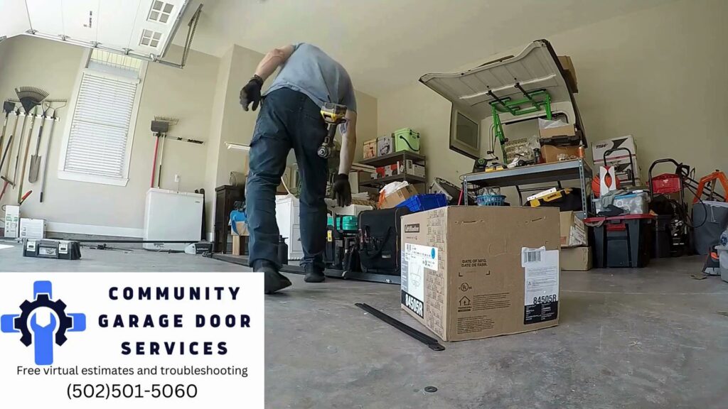 A contractor preparing for a garage door installation or repair inside a garage, showing work by Community Garage Door Services in Louisville, KY.