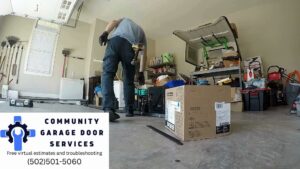 A contractor preparing for a garage door installation or repair inside a garage, showing work by Community Garage Door Services in Louisville, KY.
