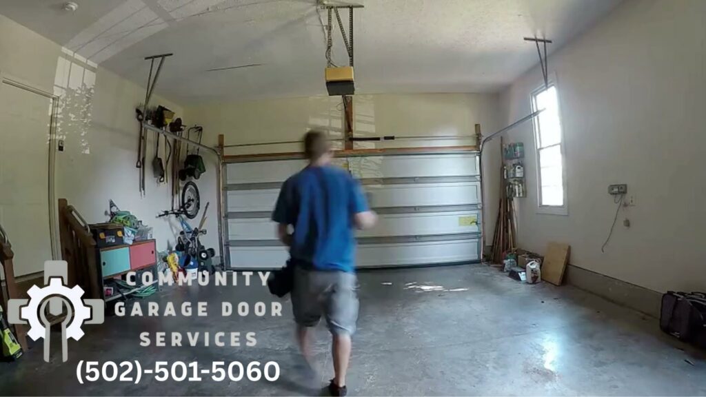 A contractor walking inside a garage after working on a white garage door, showcasing services by Community Garage Door Services in Louisville, KY.