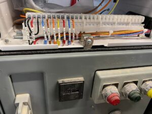 Close-up of control panel wiring and installation, showcasing work by Apex Electrical Solutions in Minot, ND.